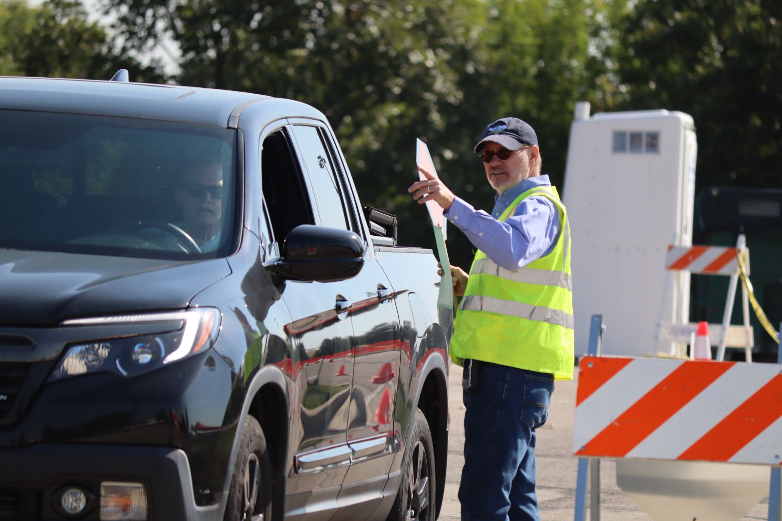 volunteer directing traffic