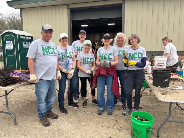 NCC green team holding trees